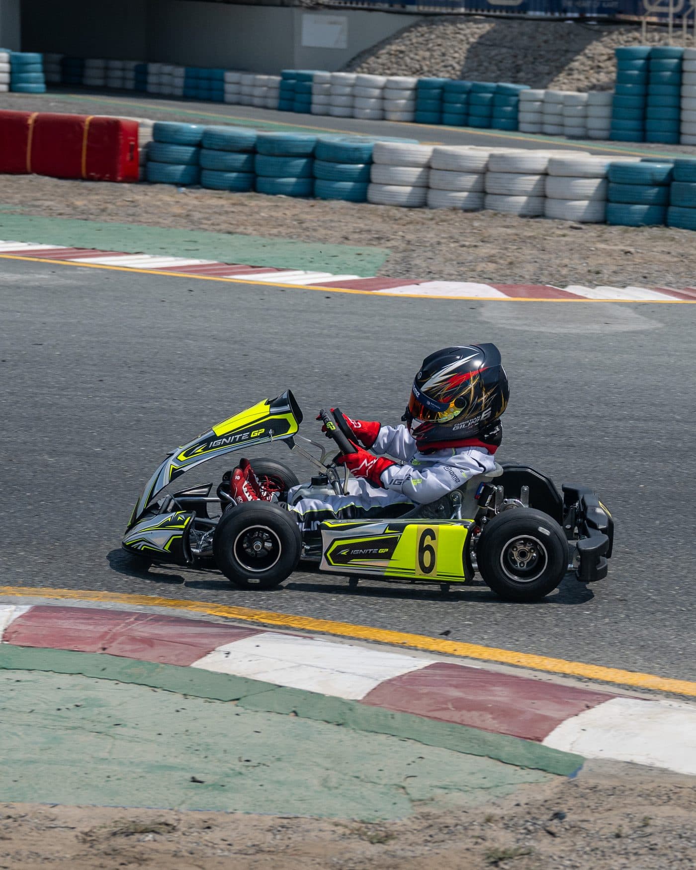 Bambino kart through the corner below the grandstand at Dubai Kartdrome