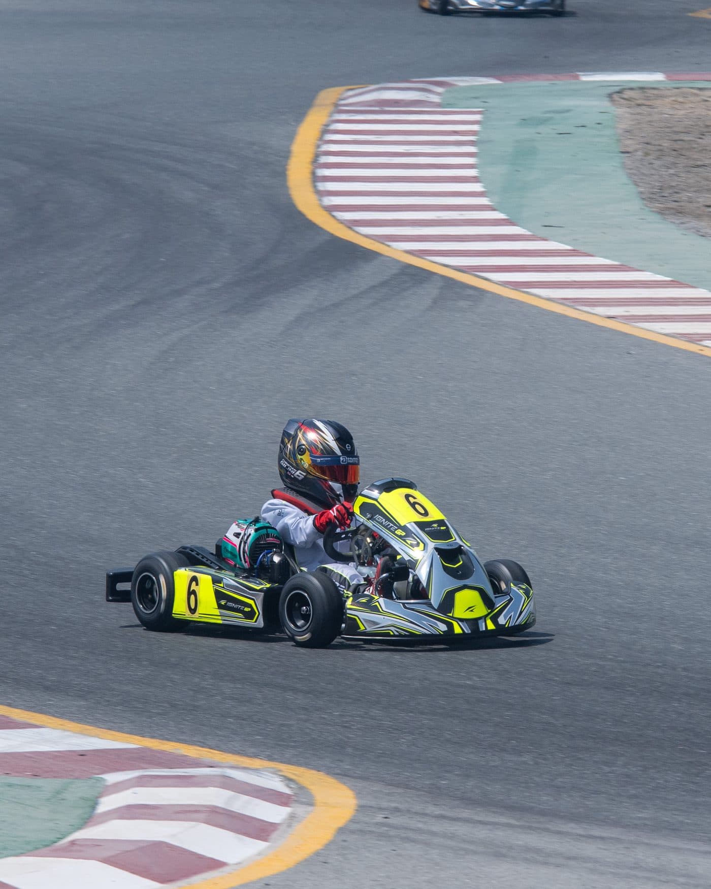 Bambino kart out of the hairpin with another kart ahead through the esses