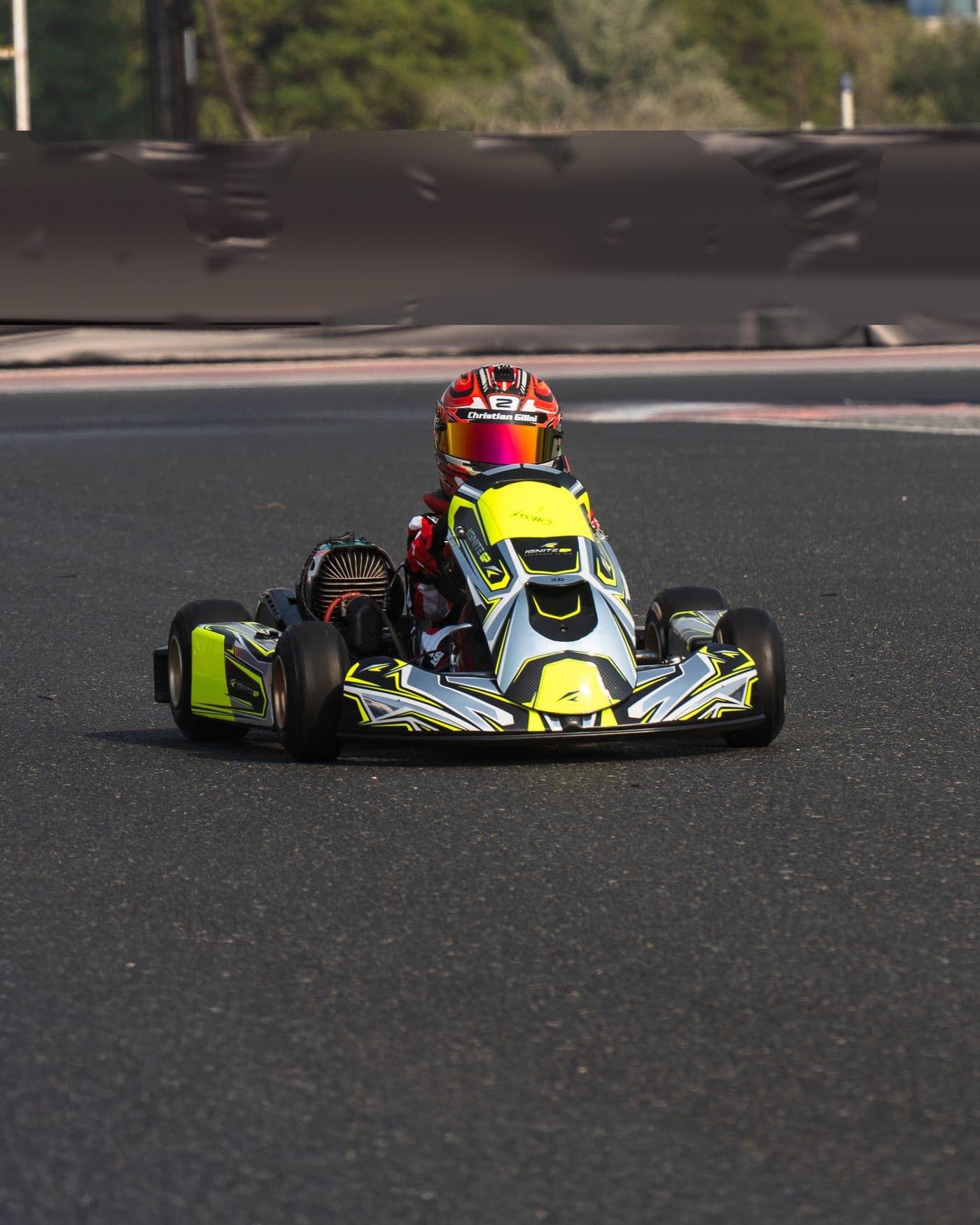Bambino driver head-on, kart square to the camera on the circuit