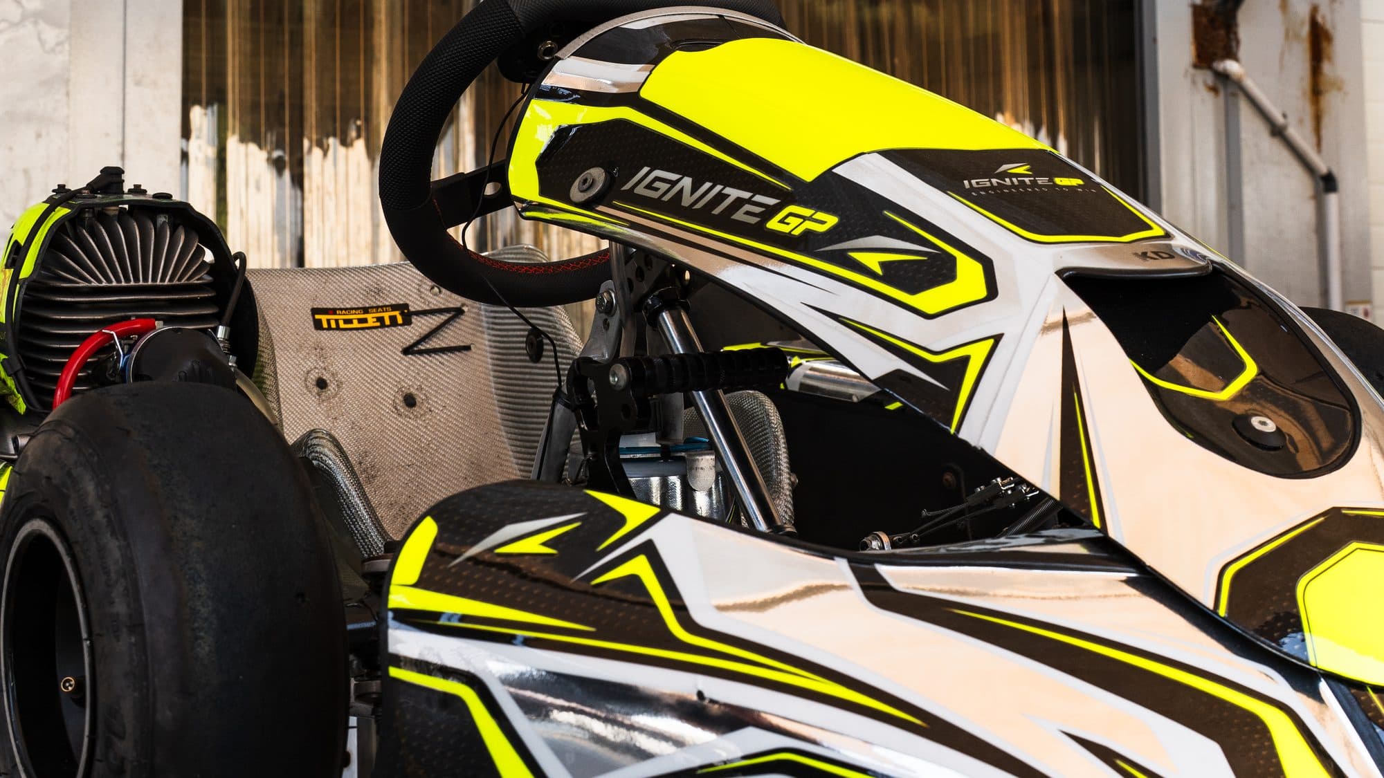 Prepared Ignite GP kart on a stand under the awning, three-quarter view