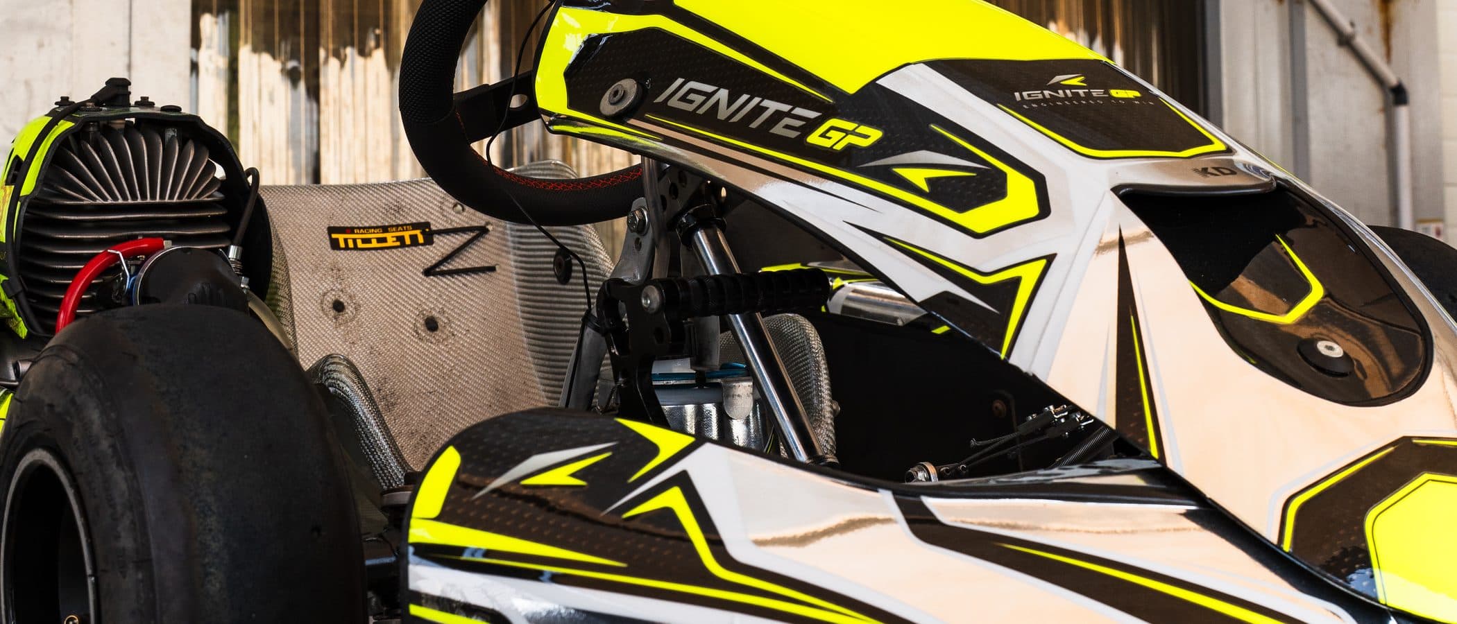 Prepared Ignite GP kart on a stand under the awning, three-quarter view