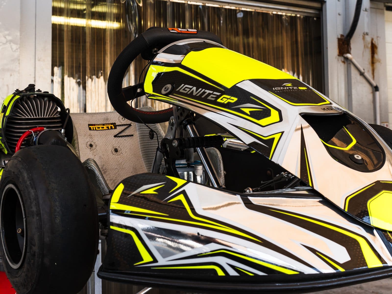 Prepared Ignite GP kart on a stand under the awning, three-quarter view