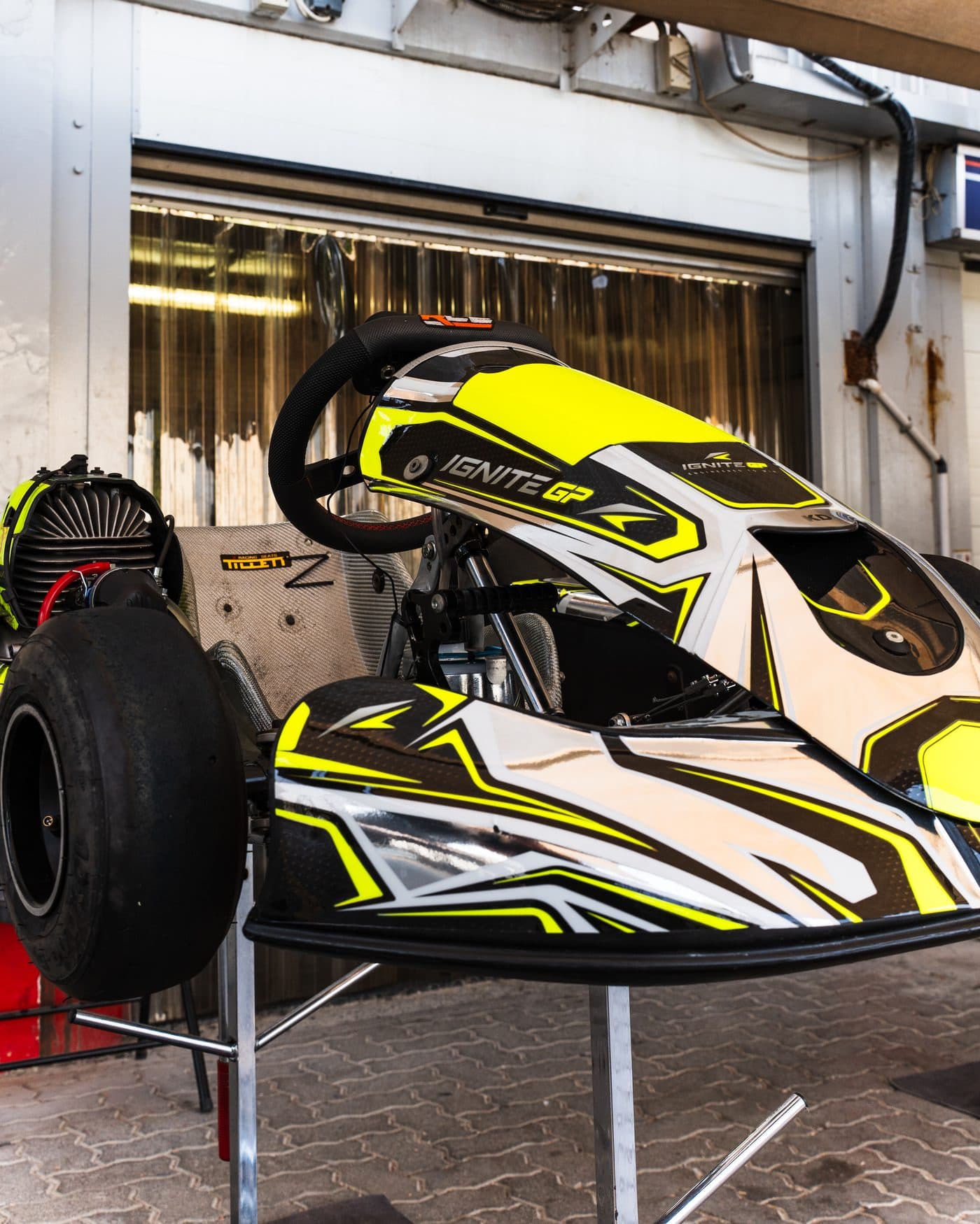 Prepared Ignite GP kart on a stand under the awning, three-quarter view