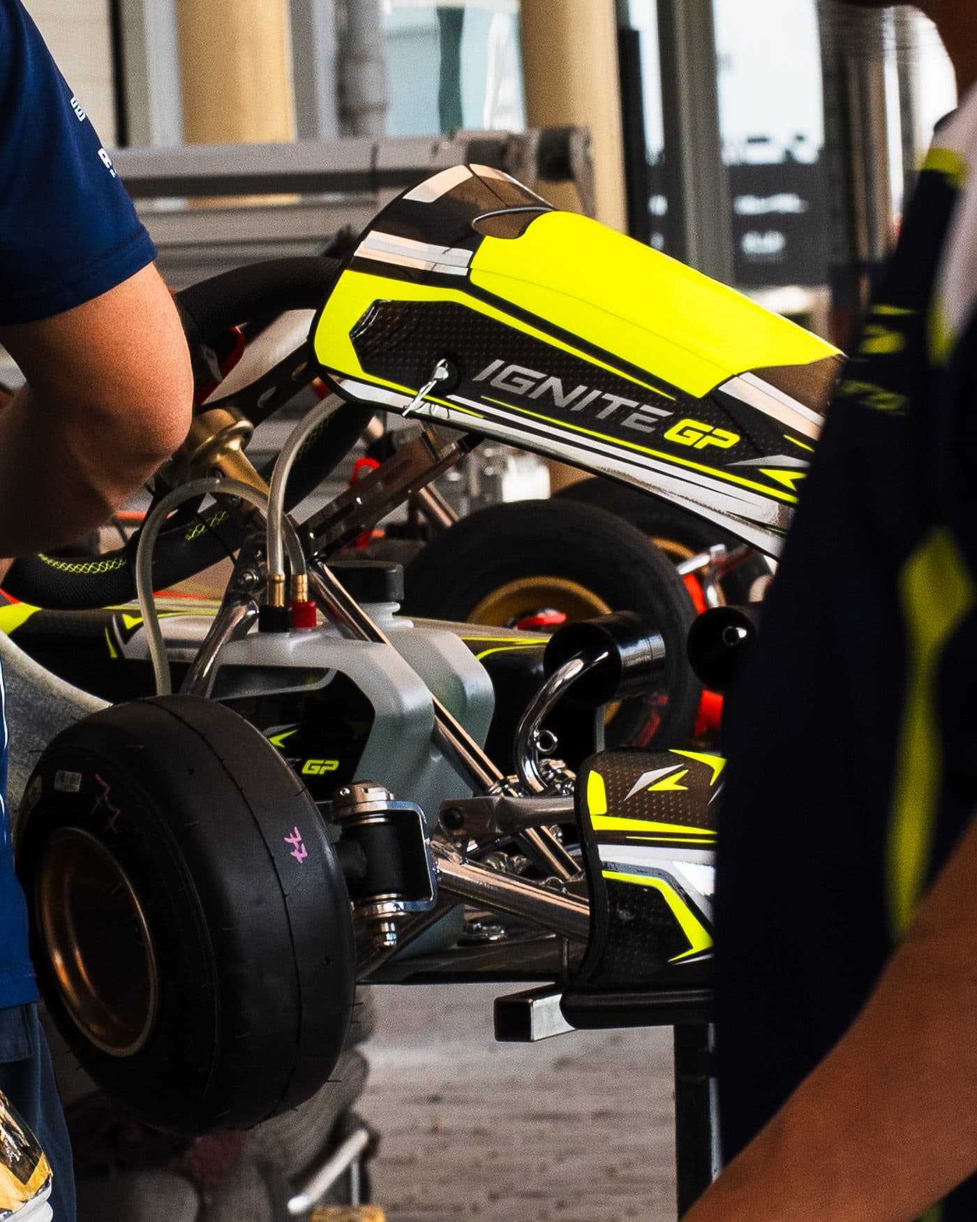 Mechanic working on an Ignite GP kart, close-up of the nassau panel and fuel tank